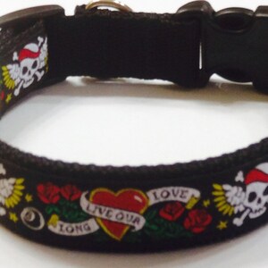 May include: Black dog collar with a colorful tattoo design featuring skulls, roses, hearts, and the text "Live our love long".