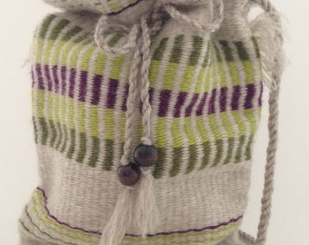 Hand woven bag with a drawstring closure. 100% wool