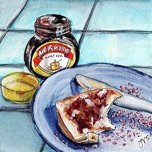 May include: A white ceramic mug with a black handle and the text "But First, Coffee" in a bold, black font. The mug is set against a blurred background, highlighting its clean design.