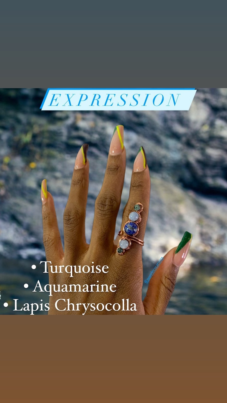 May include: A hand with long, light-colored nails with green and yellow accents. The hand is wearing a ring with turquoise, aquamarine, and lapis chrysocolla stones. The text "EXPRESSION" is at the top of the image. The text "Turquoise", "Aquamarine", and "Lapis Chrysocolla" is at the bottom of the image.
