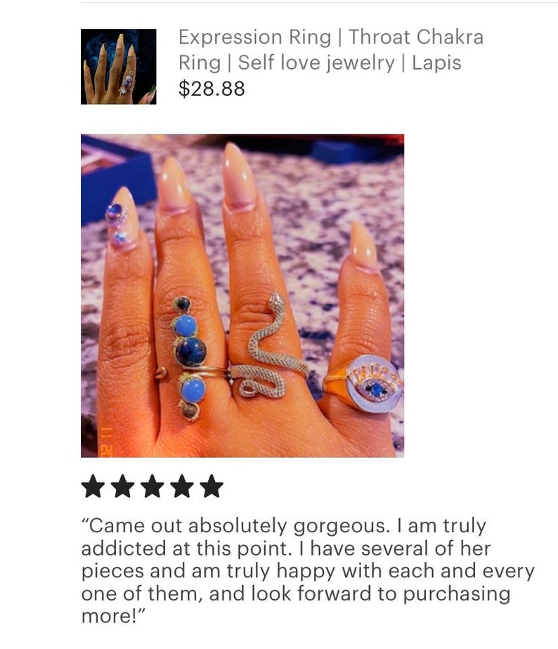 May include: A hand wearing several rings, including a snake ring, a ring with a blue eye, and a ring with blue and green stones. The rings are on a finger with nude nail polish. "Came out absolutely gorgeous. I am truly addicted at this point. I have several of her pieces and am truly happy with each and every one of them, and look forward to purchasing more!"