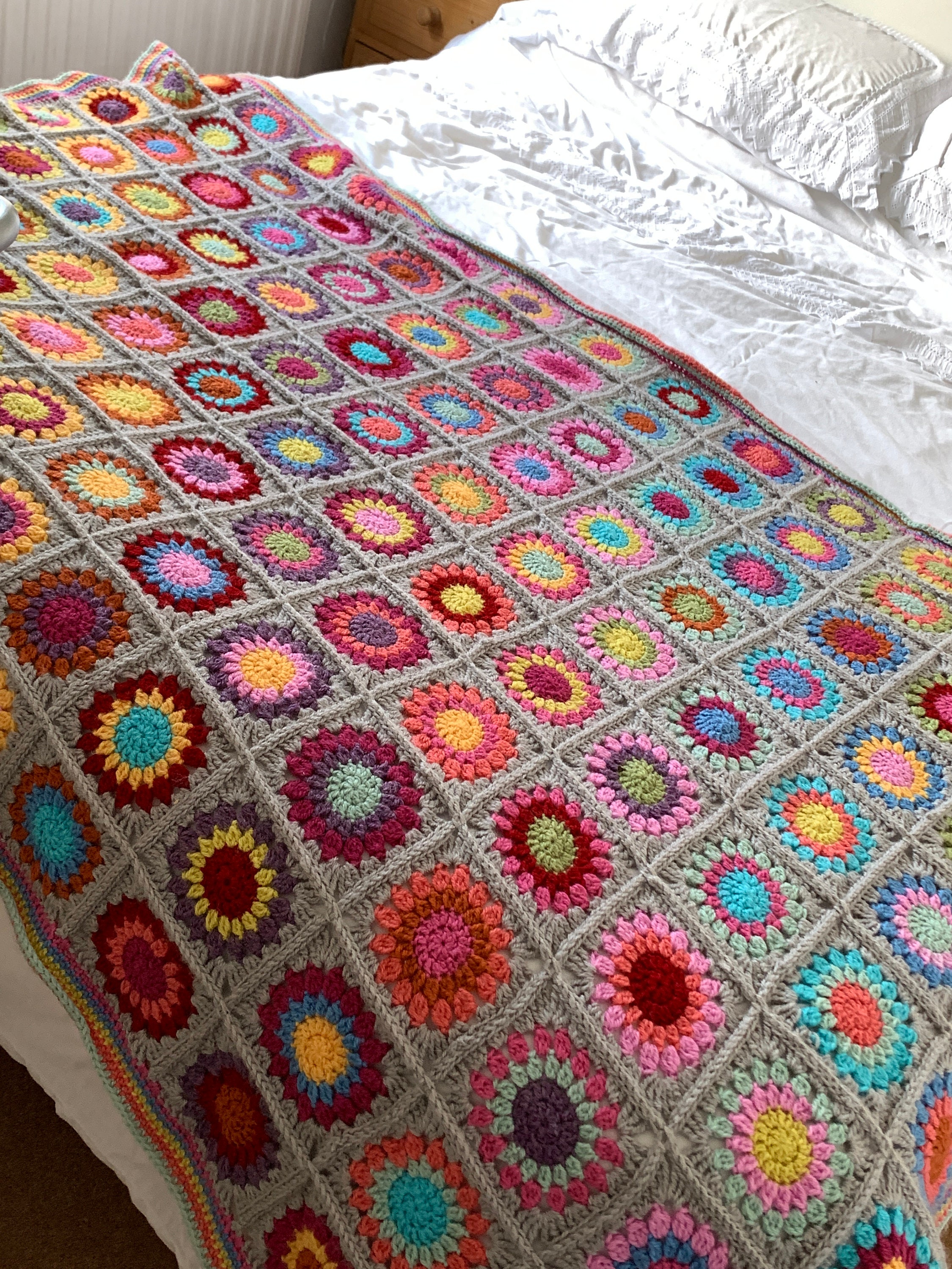 38 Sunburst Crochet Patterns for Blankets, Bags, Tops, and Home Decor 7 Starburst/ Sunburst Rainbow Granny Square Crochet
