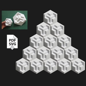 Puede incluir: Un modelo de papel blanco de una forma geométrica, que se asemeja a un cubo tridimensional, se muestra en una disposición triangular. El modelo está formado por múltiples unidades idénticas, creando un patrón complejo y visualmente interesante.