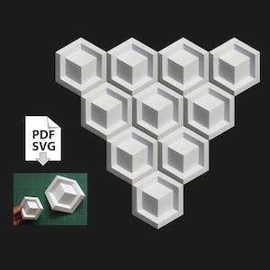 May include: A white geometric honeycomb design made of paper. The design is in the shape of a triangle with the point facing up. The design is made up of 10 individual hexagonal shapes.