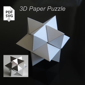 May include: A white 3D paper puzzle in the shape of a star. The puzzle is assembled and sitting on a black surface. A smaller image of the puzzle in a silver color is shown in the lower left corner of the image. The text "3D Paper Puzzle" is written in black above the puzzle. The text "PDF SVG" is written in black on a white icon of a document with a downward arrow.