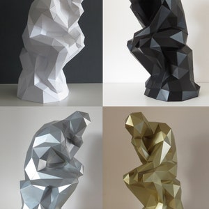 May include: Four paper mache sculptures of the "Thinker" statue in white, black, silver, and gold.