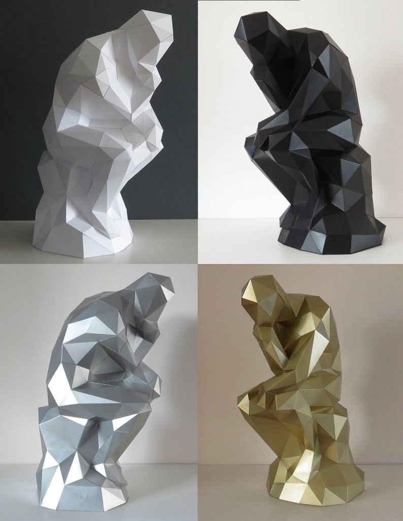 May include: Four paper mache sculptures of the "Thinker" statue in white, black, silver, and gold.