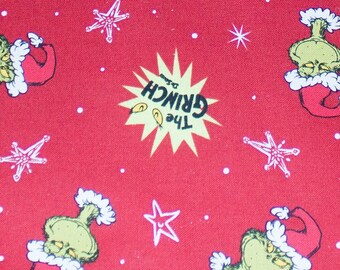 May include: Red Christmas tree skirt featuring a repeating pattern of the Grinch in a Santa hat, white stars, and the text "The Grinch" in a yellow burst. The skirt has a curved edge and a stitched border.