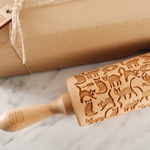 Wooden rolling pin laser engraved with design of cartoon funny cats.