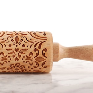 Wooden embossing rolling pin with moodforwood logo on the handle, embossing design is rosemaling, norwegian folk.