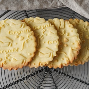 Cookies with embossed graduation congratulations pattern – festive homemade treats