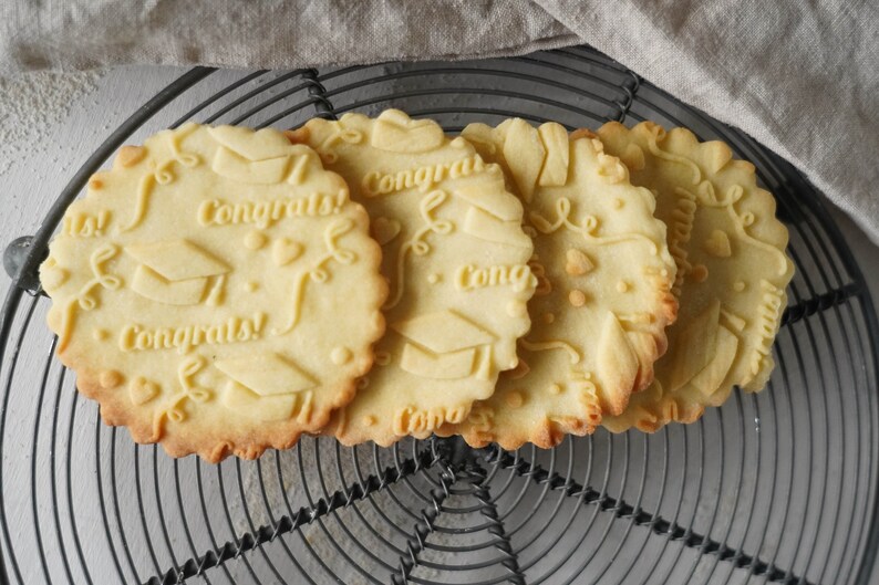 Cookies with embossed graduation congratulations pattern – festive homemade treats