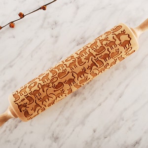 Wooden rolling pin laser engraved with design of cartoon funny cats.