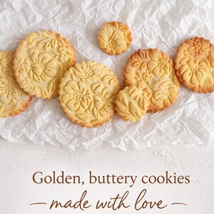 Top view of several embossed cookies arranged on a light kitchen surface showing the repeating floral texture created by the rolling pin. The decorative pattern adds a professional handmade look to homemade cookies and biscuits.