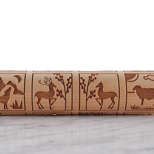 Wooden rolling pin laser engraed to make biscuits with different animal designs.