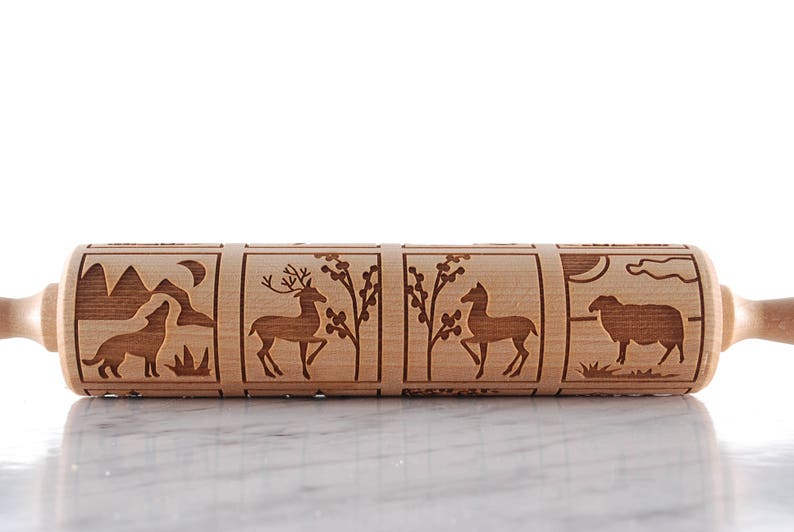 Wooden rolling pin laser engraed to make biscuits with different animal designs.