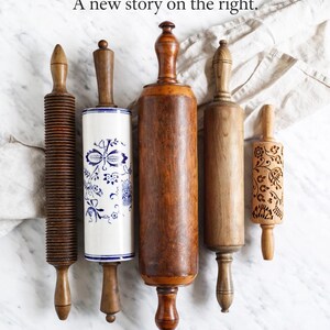 May include: An assortment of wooden rolling pins, each with a unique design. The rolling pins vary in color from light to dark brown, with one featuring a blue and white floral pattern. Text on the image reads: Tradition on the left. A new story on the right. Meet MoodForWood.
