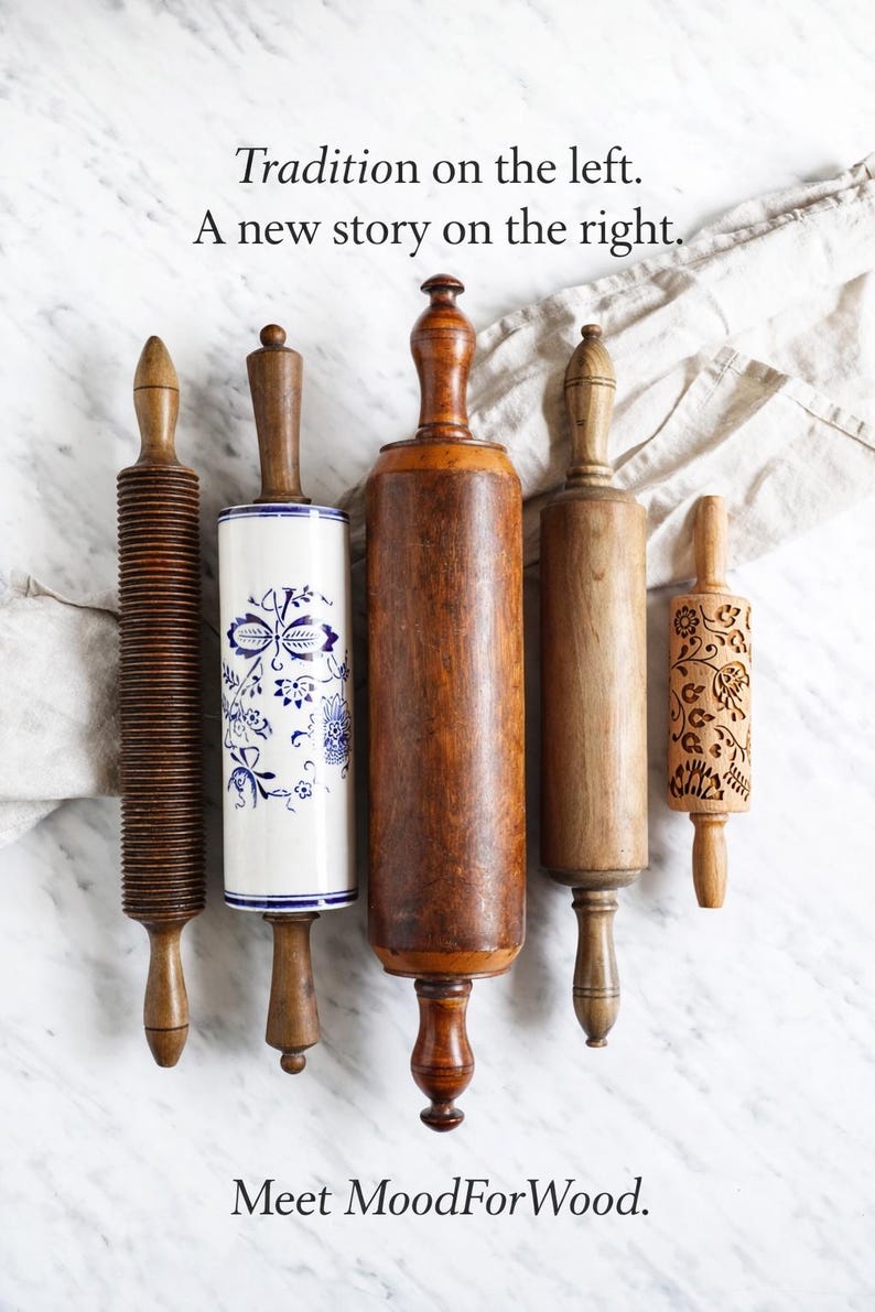 May include: An assortment of wooden rolling pins, each with a unique design. The rolling pins vary in color from light to dark brown, with one featuring a blue and white floral pattern. Text on the image reads: Tradition on the left. A new story on the right. Meet MoodForWood.