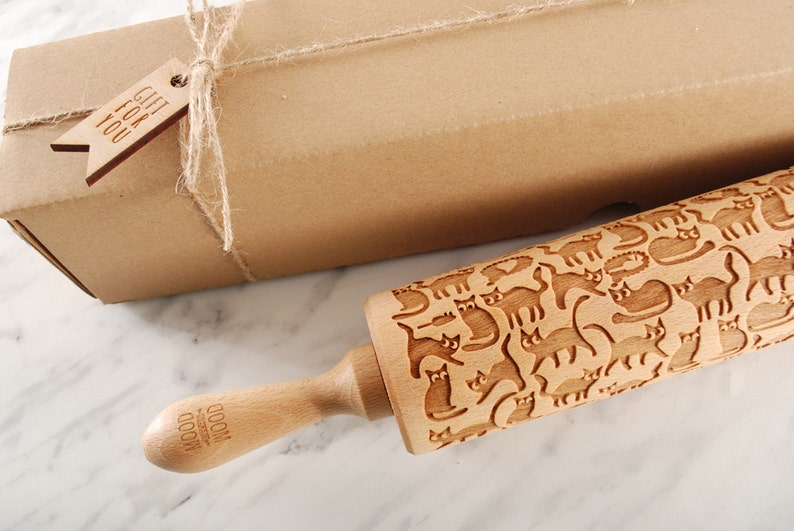 Wooden rolling pin laser engraved with design of cartoon funny cats.