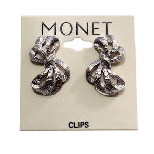 Monet Big Bow Ribbon Clip On Earrings Silver Tone Vintage 1970s PAT'D Textured Open Rib Tied Draped Loops Comfort Paddle Signed