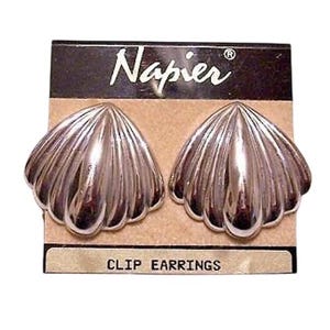 May include: A set of three ceramic mugs with a speckled, matte finish. Each mug features a different color: light blue, cream, and gray. The mugs have a simple, modern design with a rounded shape and a comfortable handle.