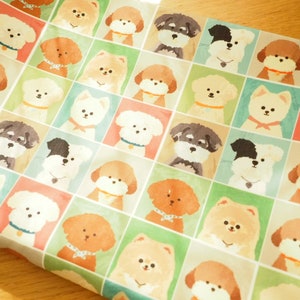 May include: A white fabric with a repeating pattern of various dog breeds in colorful squares. The dogs are illustrated in a cartoon style with different expressions and poses.