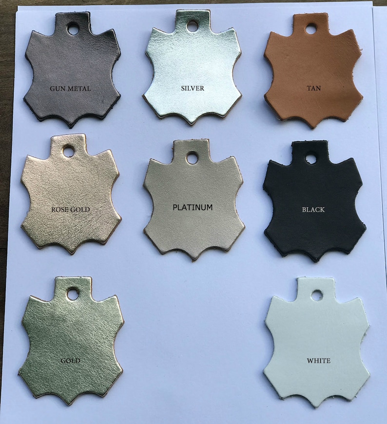 May include: Leather swatches in various colors, including gun metal, silver, tan, rose gold, platinum, black, gold, and white. Each swatch is shaped like a star with a hole in the center.