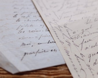May include: Close-up of two antique handwritten letters with faded ink on aged paper. The script is elegant and flowing, with visible words and phrases. The paper has a vintage, textured appearance.