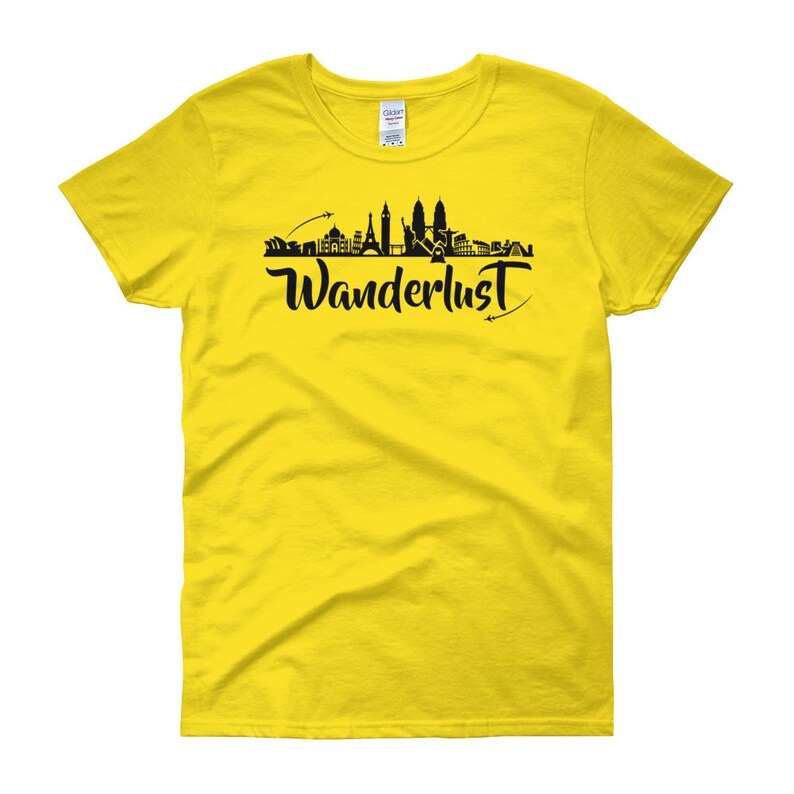 May include: Yellow women's t-shirt with a black silhouette of a city skyline and the word "Wanderlust" in black script.