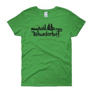 May include: A green women's t-shirt with a black silhouette of a city skyline and the word "Wanderlust" printed on the front.