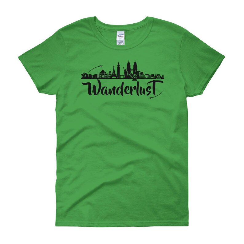 May include: A green women's t-shirt with a black silhouette of a city skyline and the word "Wanderlust" printed on the front.