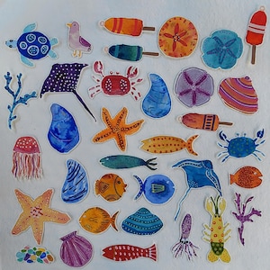 May include: A collection of watercolor-style paper cutouts featuring various marine life and beach-themed items, including a sea turtle, crab, starfish, jellyfish, stingrays, assorted fish, seashells, coral branches, and colorful buoy markers.