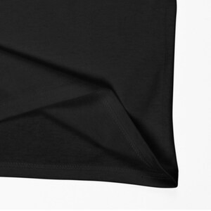 May include: Close-up of the black fabric hem of a garment, showing the stitching detail.