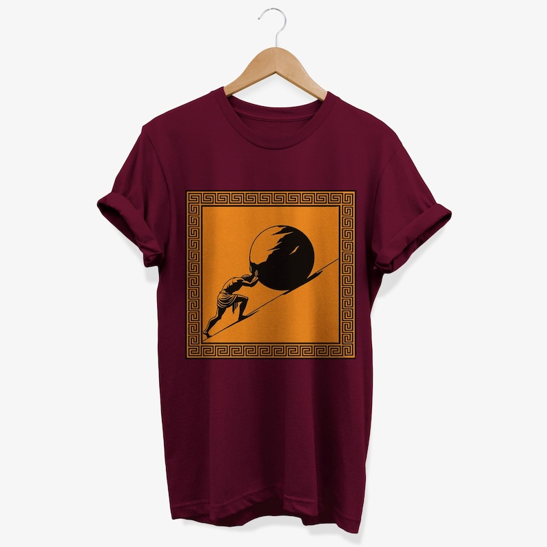 May include: A maroon t-shirt with a graphic of a person pushing a large stone uphill. The graphic is framed by a gold Greek key border and set against a yellow background.