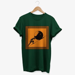 May include: A dark green t-shirt with a graphic of a person pushing a large stone uphill. The graphic is framed by a gold Greek key border and set against an orange background.