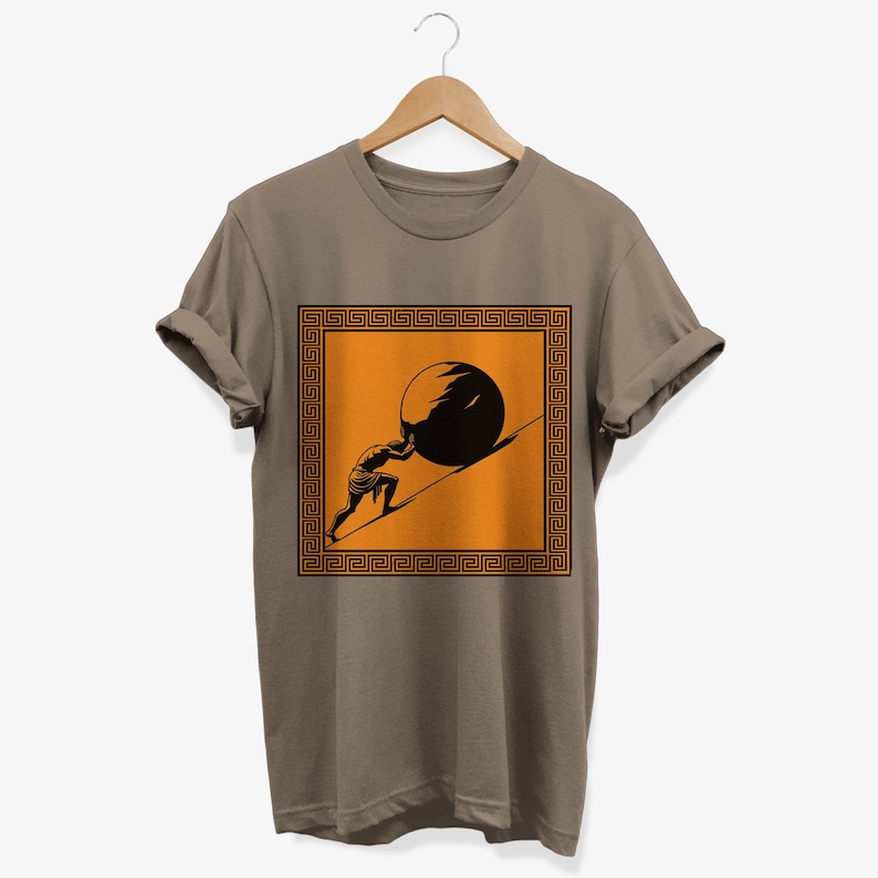 May include: A brown t-shirt with a graphic of a man pushing a boulder uphill. The graphic is framed with a Greek key border and set against an orange background.