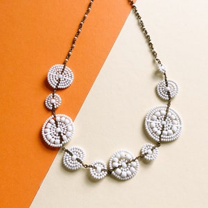 Asymmetrical white beaded necklace