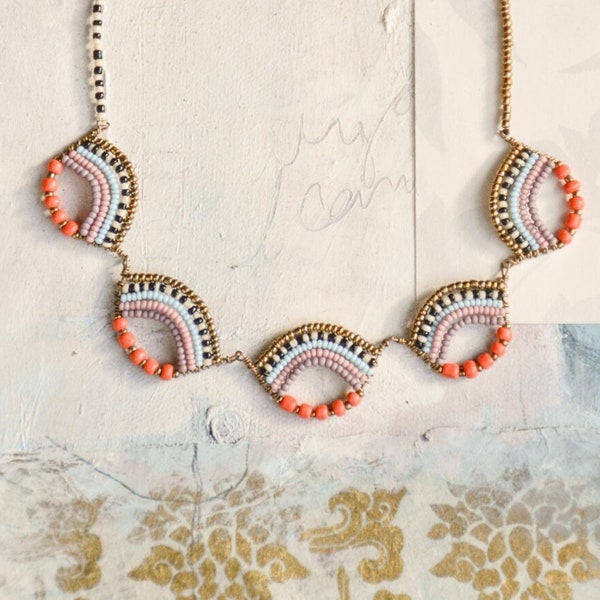 Delicate Maasai bead-work scallop necklace in bright orange, pastels and gold with a tribal influence.