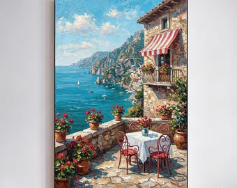 May include: Oil painting depicting an Italian coastal scene. A stone building with a red and white striped awning and balcony overlooks the turquoise sea. A table and chairs are set on a stone patio, surrounded by potted red flowers. The artwork is framed.