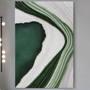 May include: A rectangular wall art piece featuring thick, textured impasto paint in shades of deep forest green, sage green, and white. The composition consists of sweeping, curved lines and organic shapes that create a sense of movement and depth.