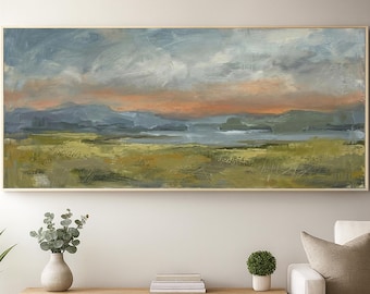 May include: A large rectangular landscape painting featuring a wide field of olive green and yellow grasses in the foreground, with a body of water and distant blue-grey mountains under a cloudy sky with streaks of soft orange sunset light.