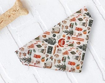 May include: A triangular pet bandana featuring a repeating pattern of holiday-themed illustrations including evergreen trees, orange slices, candy canes, stockings, snow globes, rolling pins, and mugs on a light off-white background.