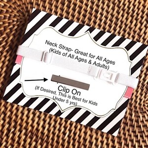 May include: White neck strap with a black and white striped background. The strap has a clip on feature and the text "Neck Strap- Great for All Ages (Kids of All Ages & Adults)" and "(If Desired, This is Best for Kids Under 5 yrs)" is printed on the background.