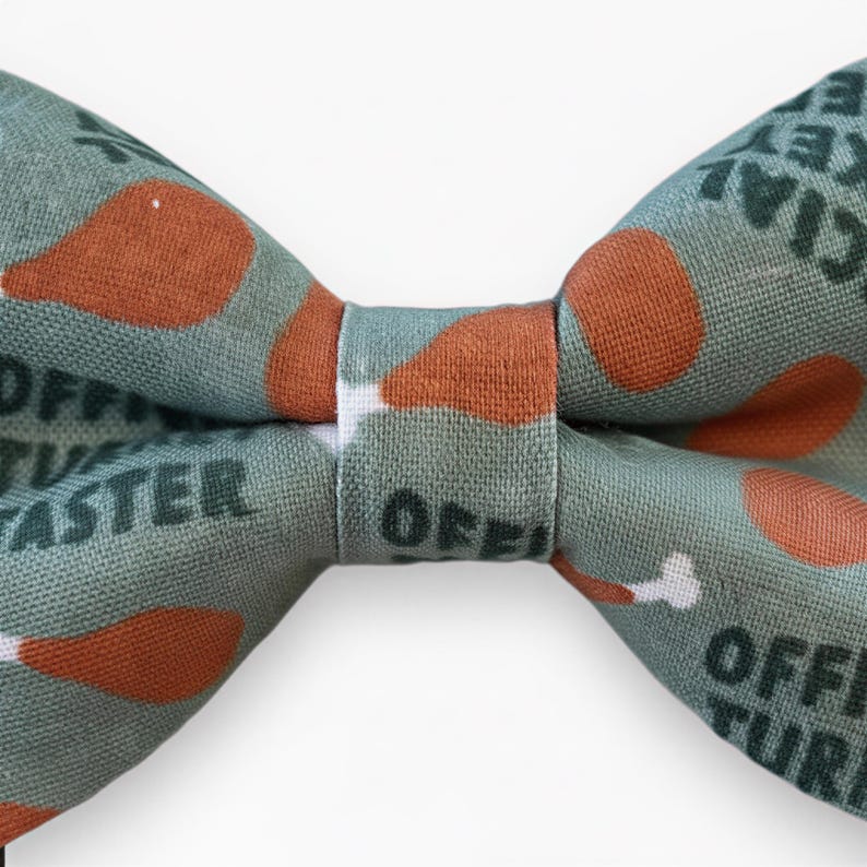 A cat bow tie for Thanksgiving with a pattern of turkeys on it.
