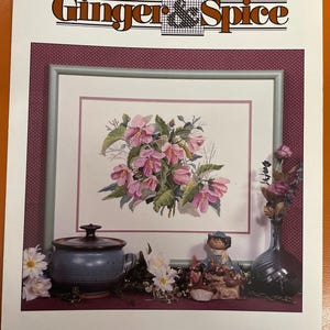 May include: Cross stitch pattern for a bouquet of pink rose mallows, titled "Rose Mallows" by Ginger & Spice. The pattern is charted and designed by Ginger Gouger Miller.