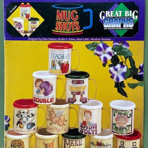 May include: A collection of 12 cross-stitch mug designs, featuring various themes and phrases like "World's Best Teacher!" and "When Pigs Fly!" The mugs have different colored rims and handles, with a yellow background.
