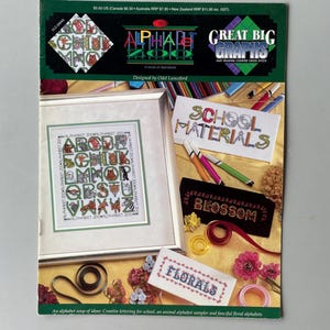 May include: A book of cross stitch patterns called "Alphabet Zoo" with a variety of animal alphabet designs. The book cover features a colorful illustration of a cross stitch alphabet sampler with animals. The book also includes patterns for school materials, a blossom, and florals.