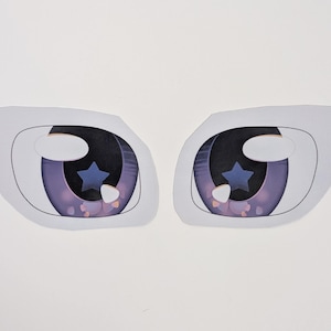 May include: Two eye-shaped cutouts with a white outline and a mesh texture. The irises are a gradient of purple and black, with a blue star detail. The eyes are designed for crafts or cosplay.