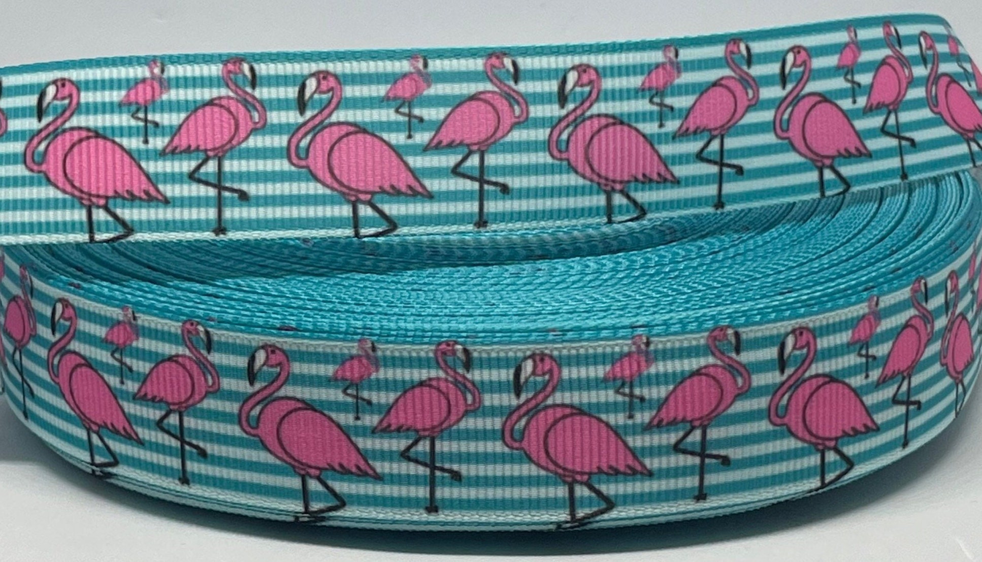 Flamingos in a row on 5/8 Lt. pink single face satin ribbon, 10 Yards