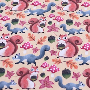 May include: A beige fabric with a repeating pattern of red squirrels holding acorns, blue squirrels, and brown leaves. The background is a light beige color.